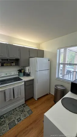 a kitchen with a stove a sink and a refrigerator
