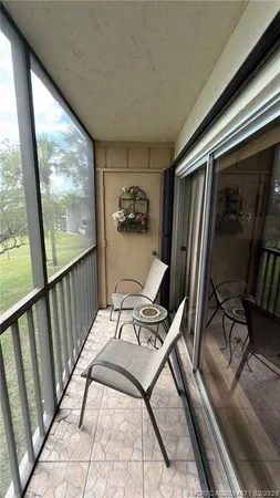 a view of a hallway with two chairs and a couch