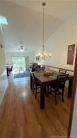 a view of a dining room with furniture wooden floor and chandelier