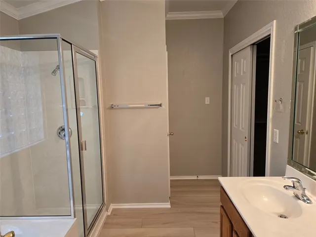 a bathroom with a shower and a sink