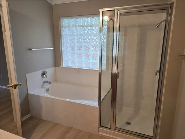 a white bath tub sitting next to a shower