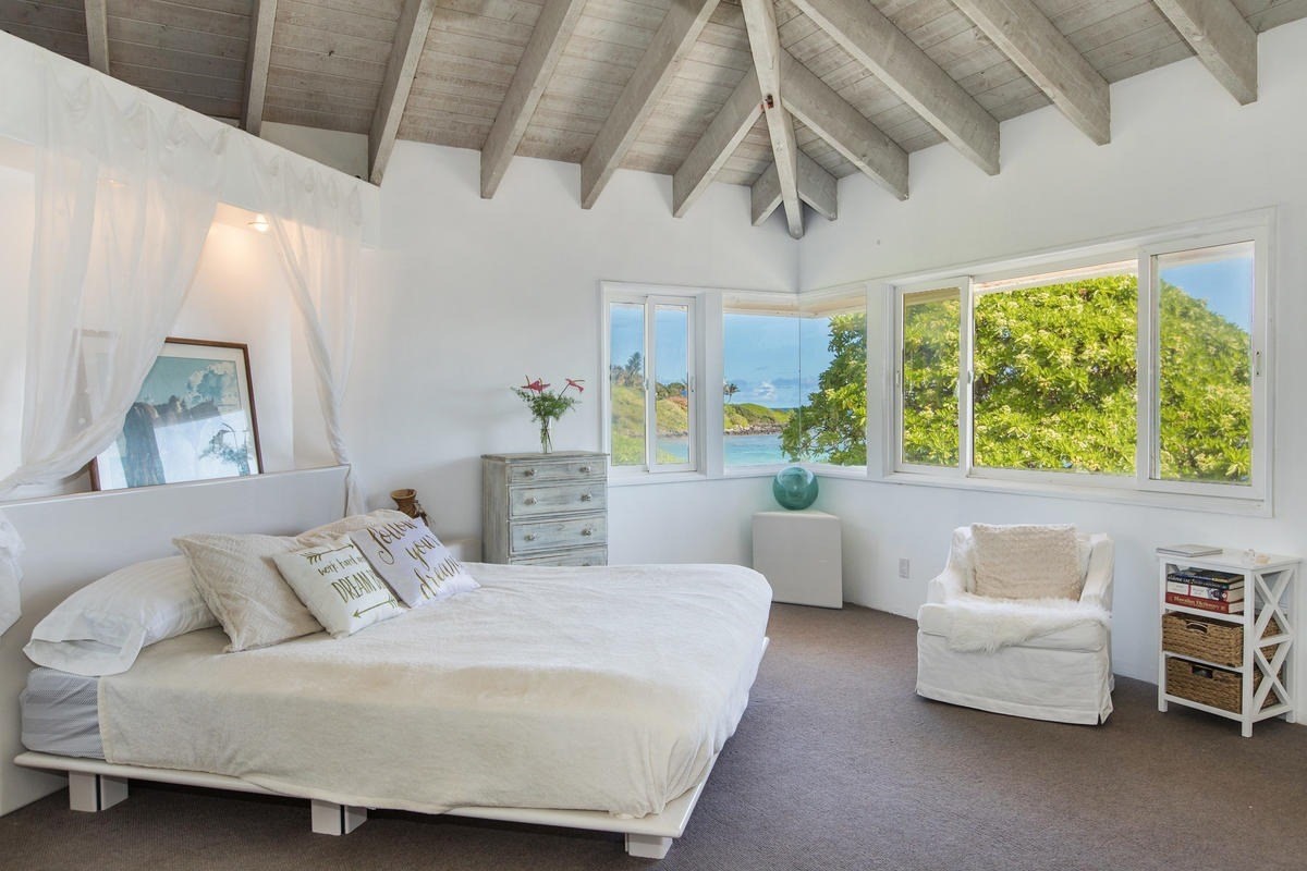 5040 Aliomanu Road Kilauea, HI 96754 - Photo 18 of 23 a bedroom with a large bed couch and a window
