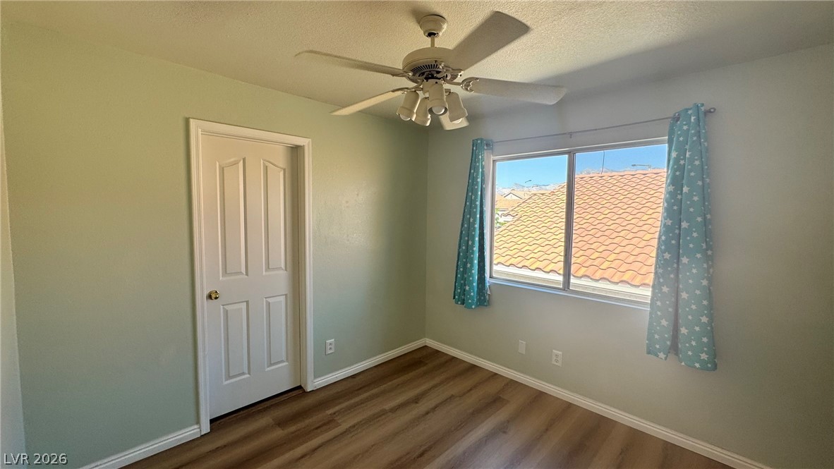 9716 Ridge Creek Place Las Vegas, NV 89134 - Photo 18 of 28 This versatile bedroom offers durable flooring and natural light, perfect for personalization.