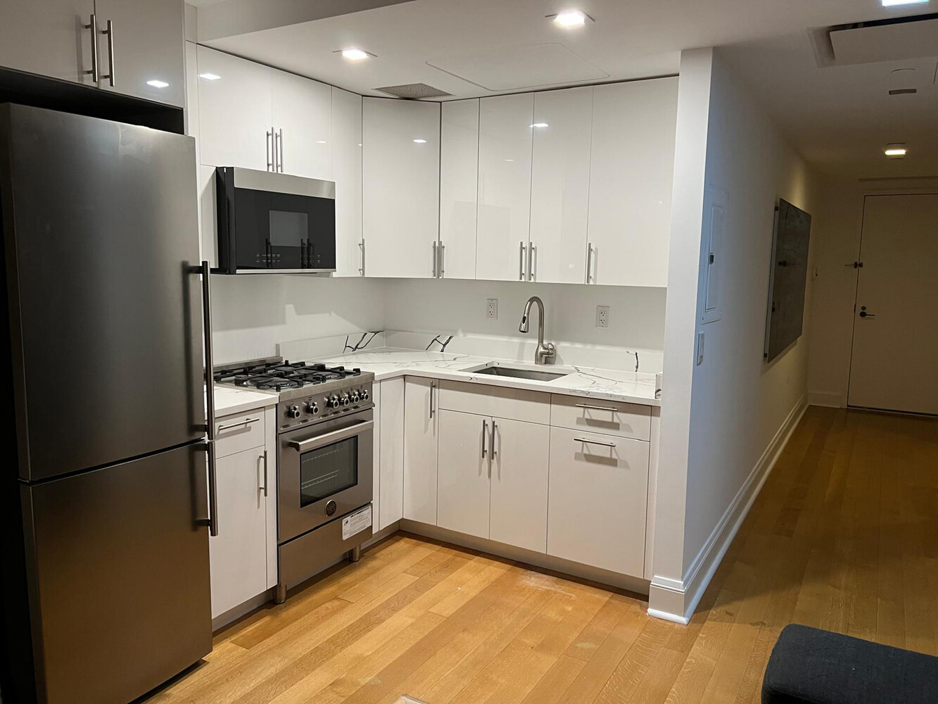 170 East End Avenue, Unit 1D Manhattan, NY 10128 - Photo 3 of 8 a kitchen with a sink cabinets and stainless steel appliances