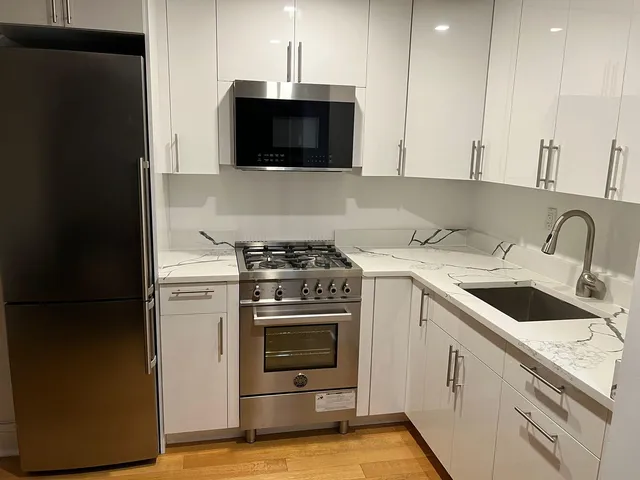 a kitchen with a sink cabinets and stainless steel appliances