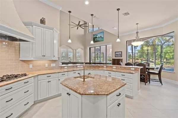 a dining room with furniture a chandelier and window