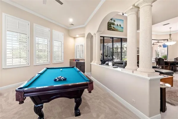 a spacious bedroom with a bed a couch and a chandelier