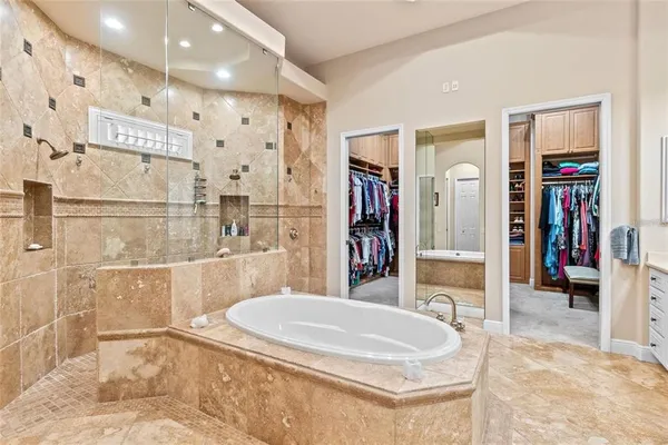 a bedroom with a bed and a flat tv screen on the dresser