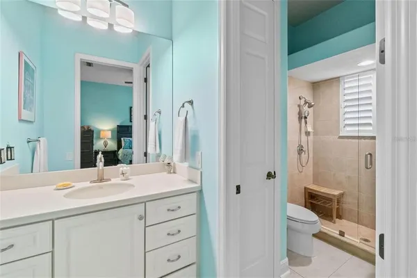 a living room with patio furniture and a floor to ceiling window