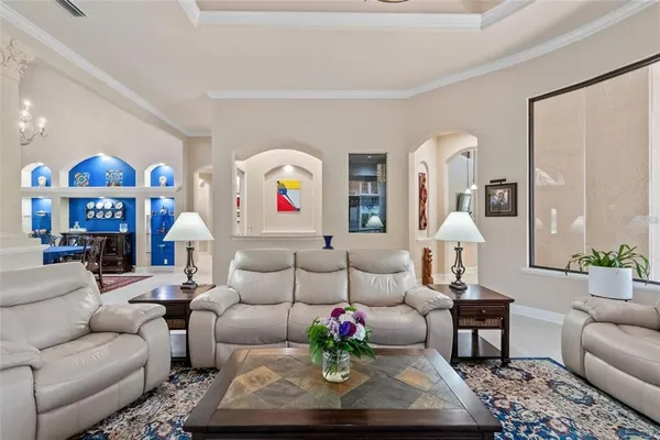 a living room with furniture a piano and a flat screen tv