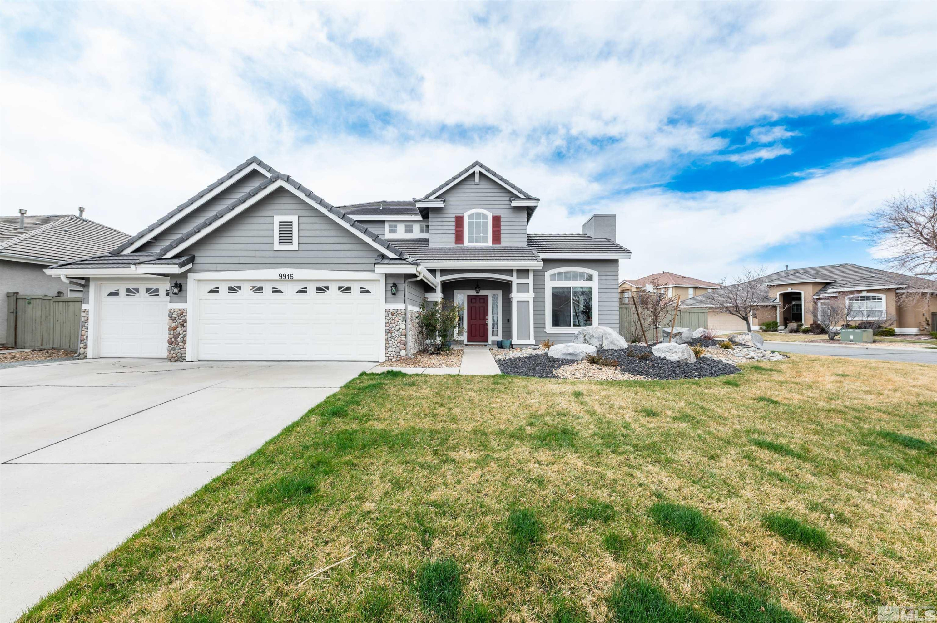 9915 Bandana Way Reno, NV 89521 - Photo 1 of 40 a front view of a house with a yard and garage