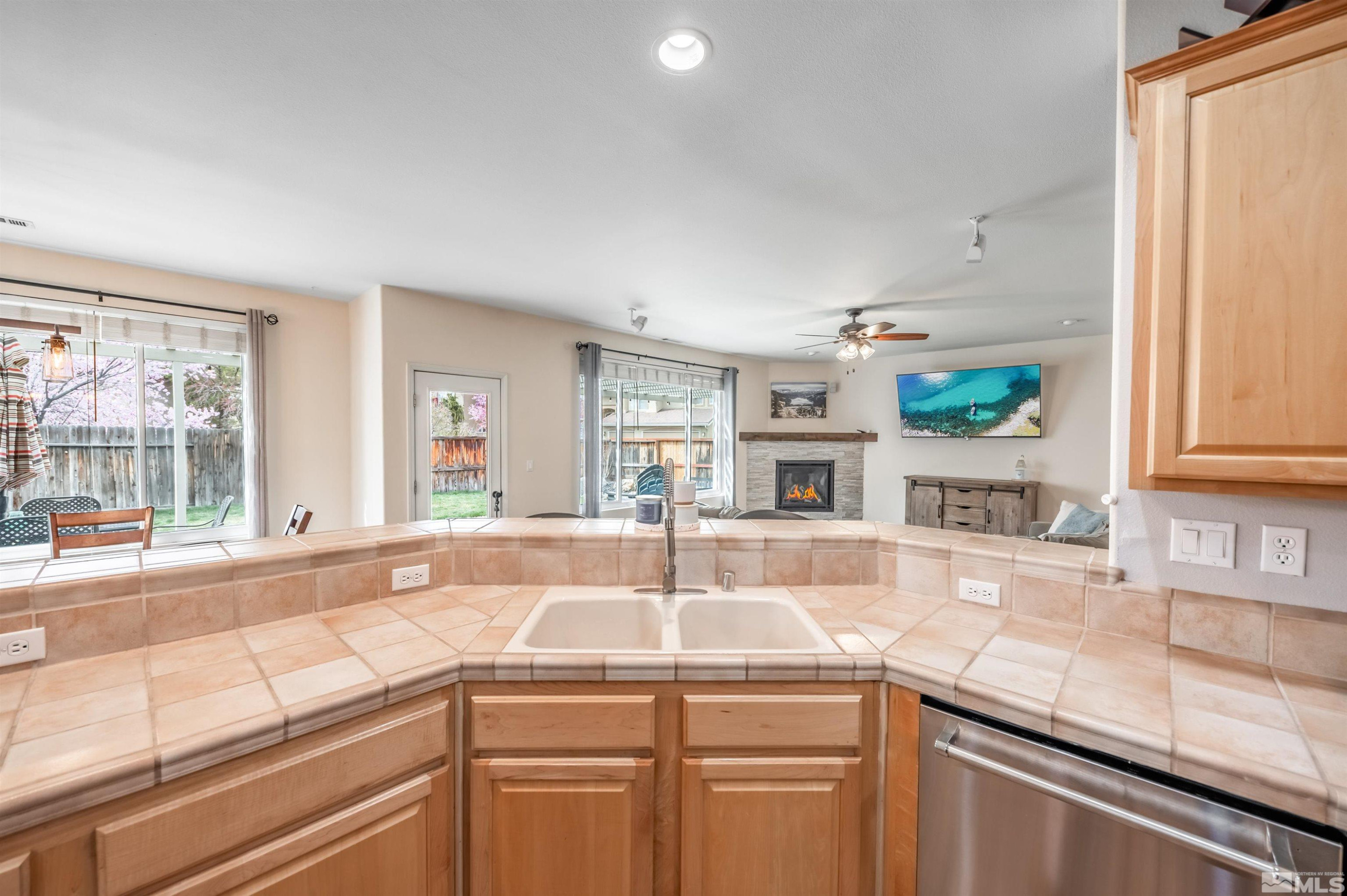 9915 Bandana Way Reno, NV 89521 - Photo 16 of 40 a kitchen with granite countertop a sink and a window