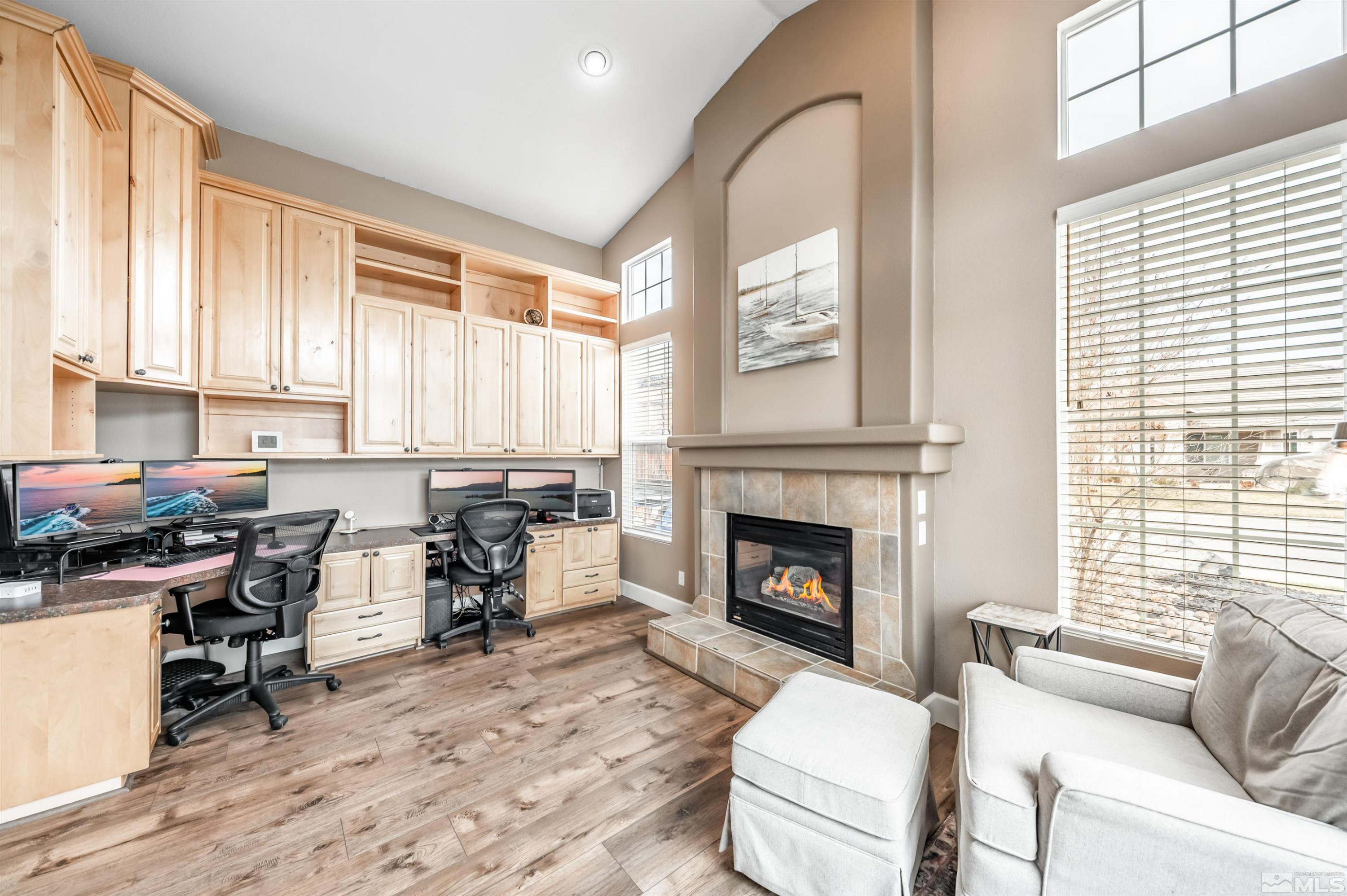 9915 Bandana Way Reno, NV 89521 - Photo 19 of 40 a living room with furniture a fireplace and large windows