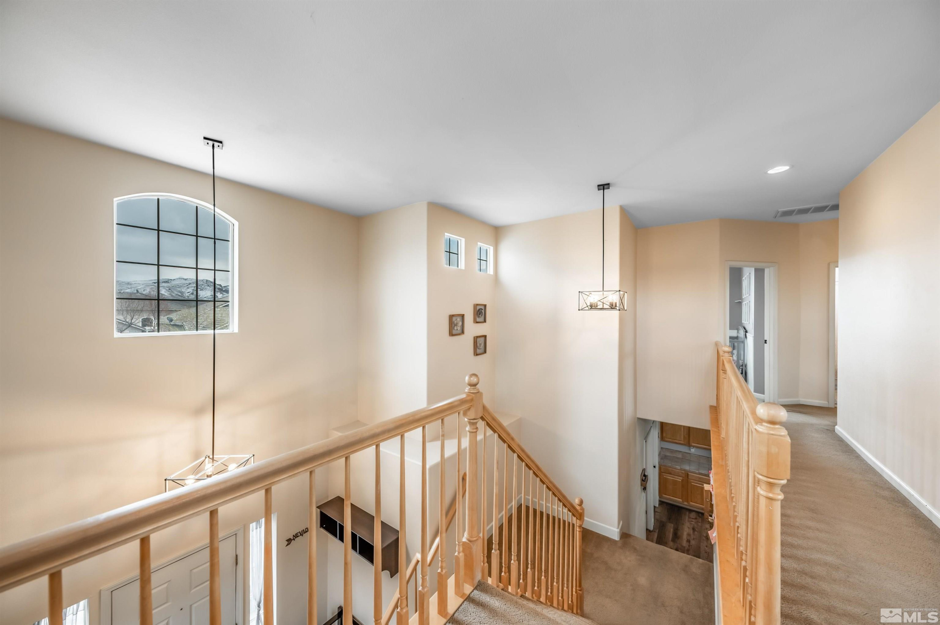 9915 Bandana Way Reno, NV 89521 - Photo 21 of 40 a view of hallway with stairs and wooden floor