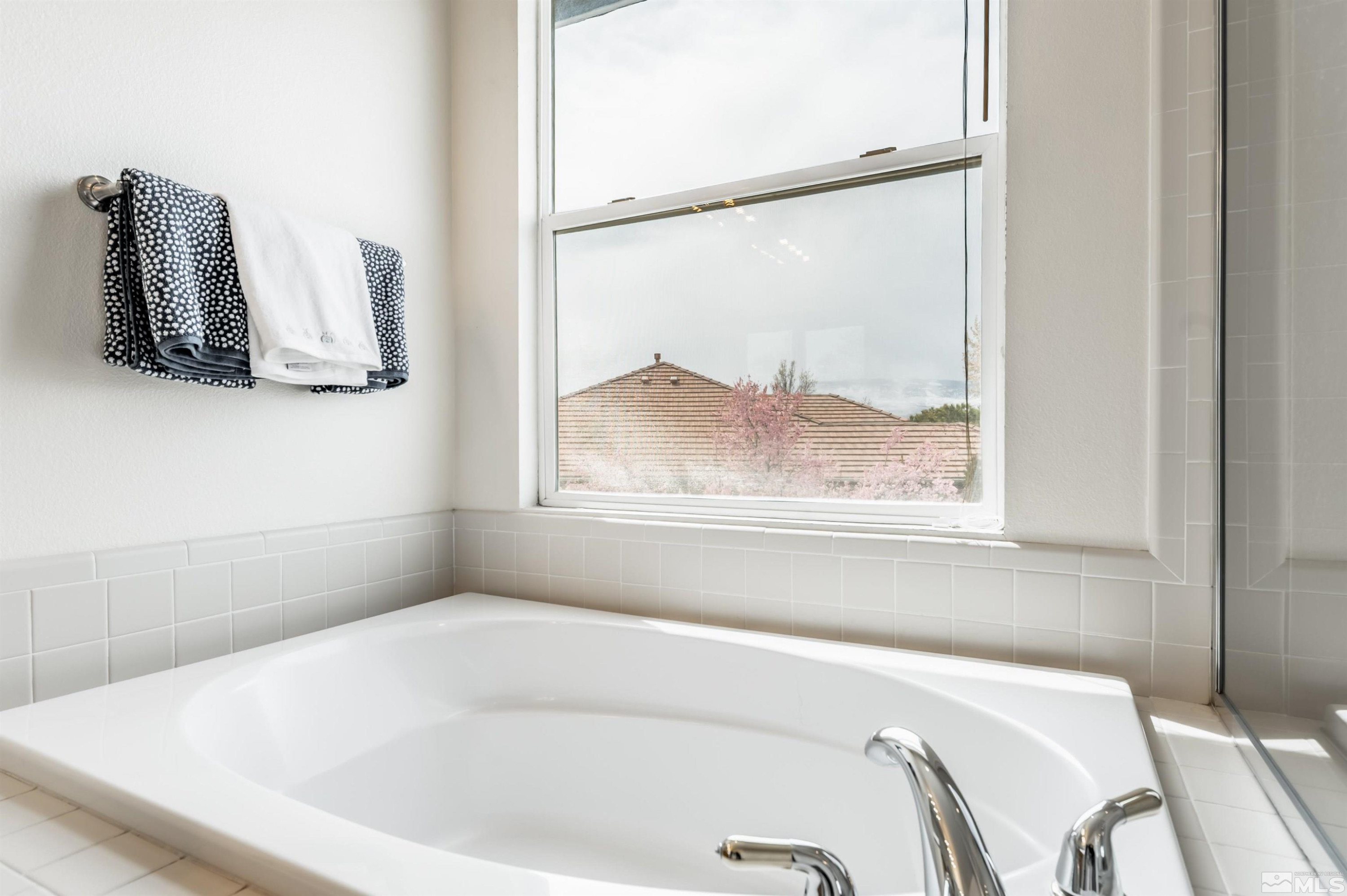 9915 Bandana Way Reno, NV 89521 - Photo 26 of 40 a white bath tub sitting next to a window
