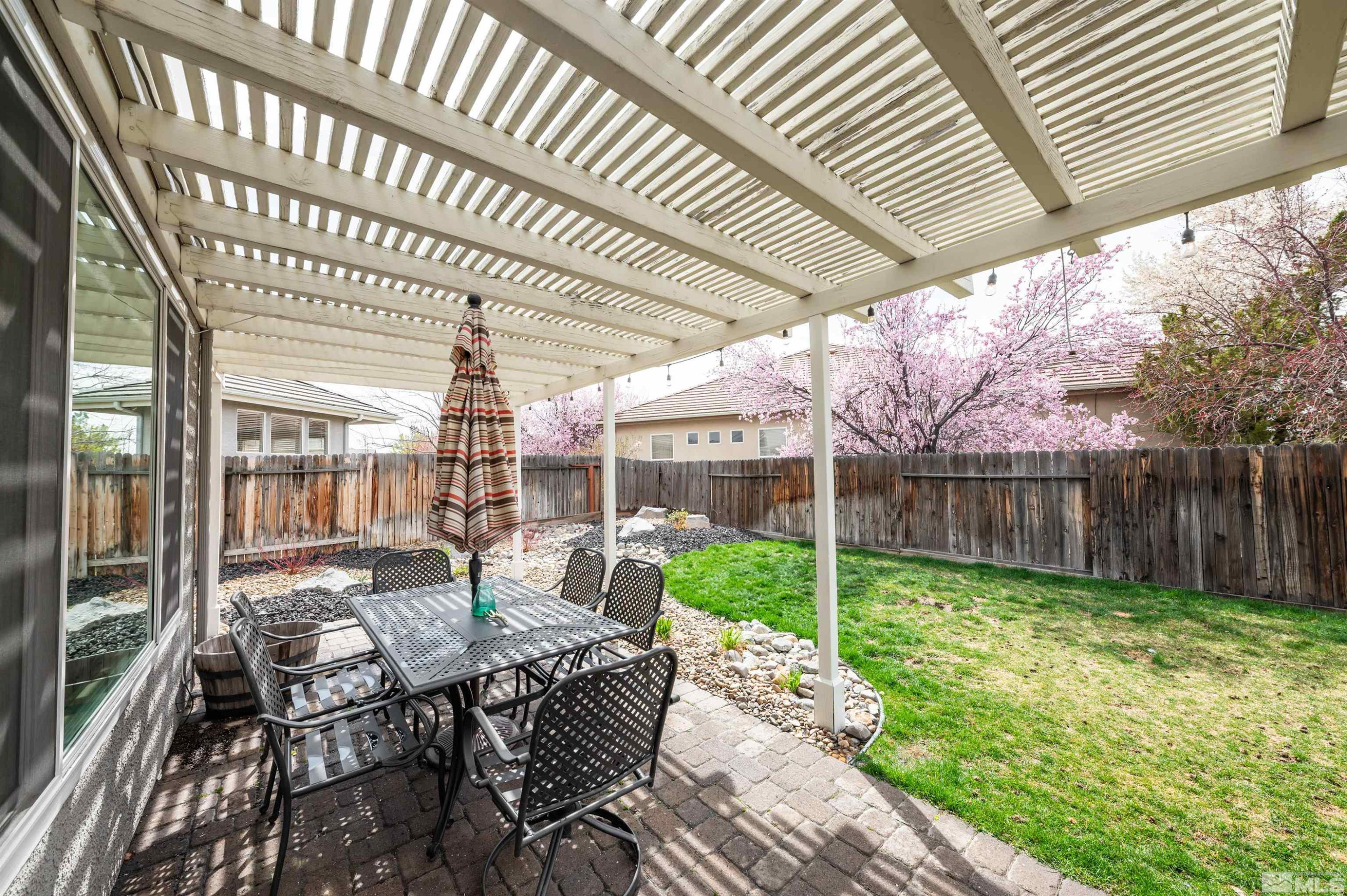 9915 Bandana Way Reno, NV 89521 - Photo 36 of 40 a view of a patio with table and chairs and wooden floor