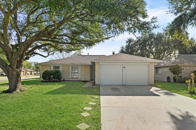 a house that has a tree in front of the house