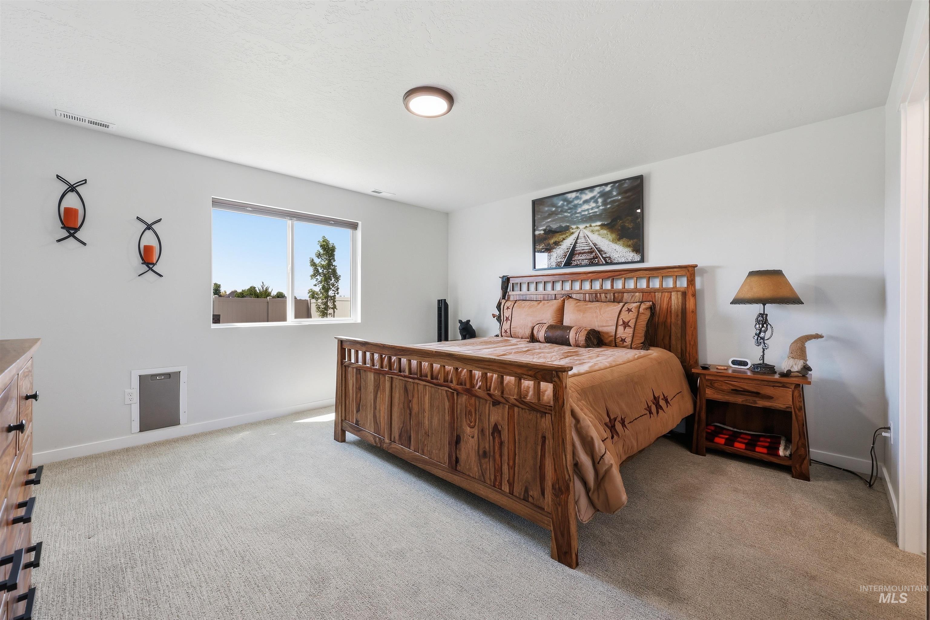 3811 West Maypearl Street Meridian, ID 83642 - Photo 23 of 39 Spacious carpeted room featuring a large window, recessed lighting, and a neutral color palette
