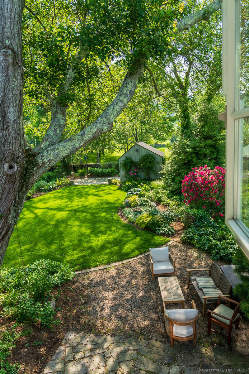 105 River Road Groton, CT 06355 - Photo 12 of 39 a view of a garden with plants and large trees