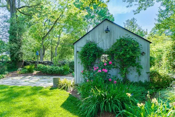 a backyard of a house with lots of green space and plants