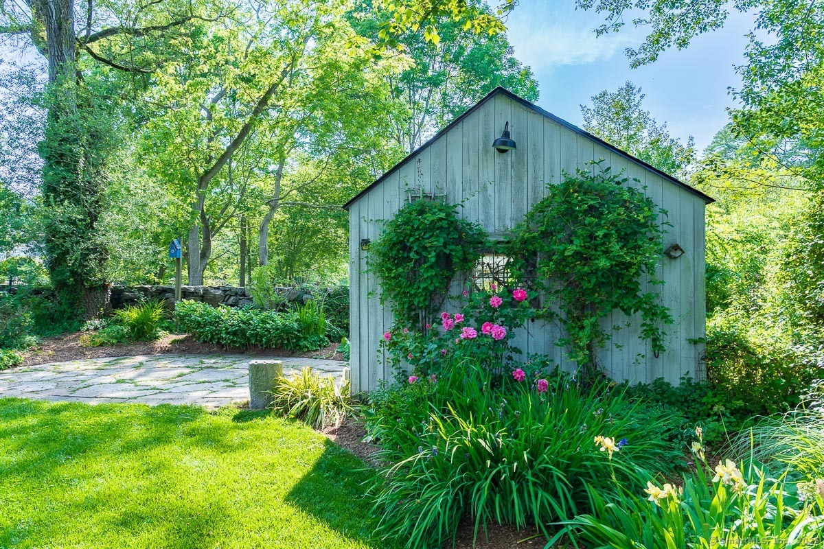 105 River Road Groton, CT 06355 - Photo 16 of 39 a backyard of a house with lots of green space and plants