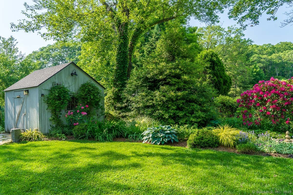 105 River Road Groton, CT 06355 - Photo 17 of 39 a view of a backyard with garden