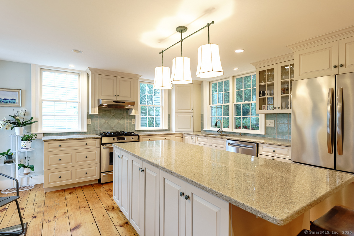 105 River Road Groton, CT 06355 - Photo 20 of 39 a kitchen with stainless steel appliances granite countertop a sink a stove and refrigerator