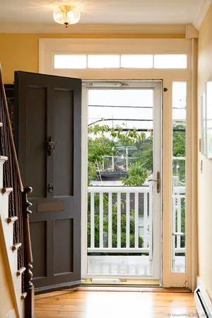a view of a livingroom with wooden floor and windows