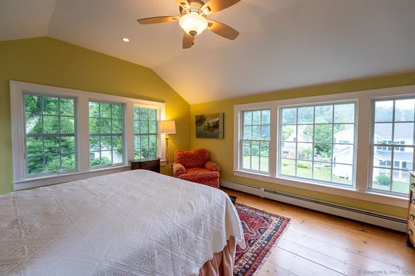 a bed sitting in a bedroom next to a window