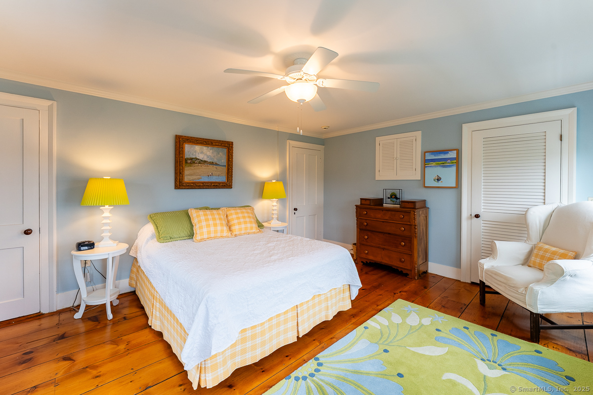 105 River Road Groton, CT 06355 - Photo 34 of 39 a bedroom with a bed and wooden floor