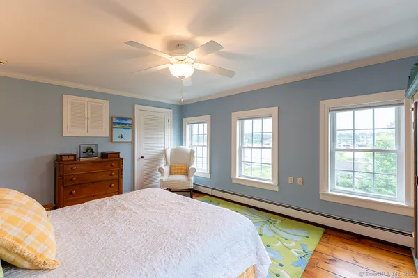 a bedroom with a bed dresser and a window