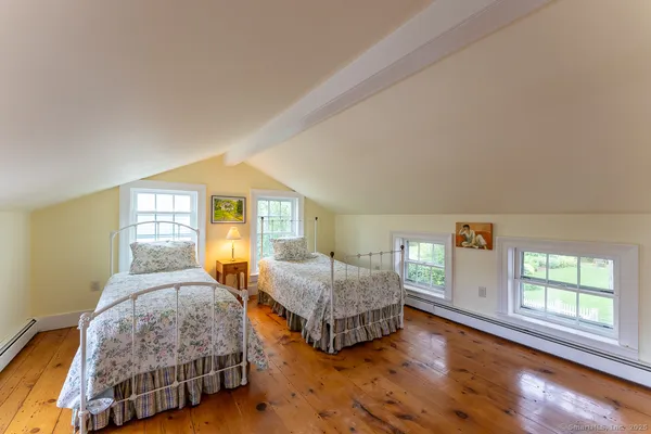 a bedroom with two beds and a large window