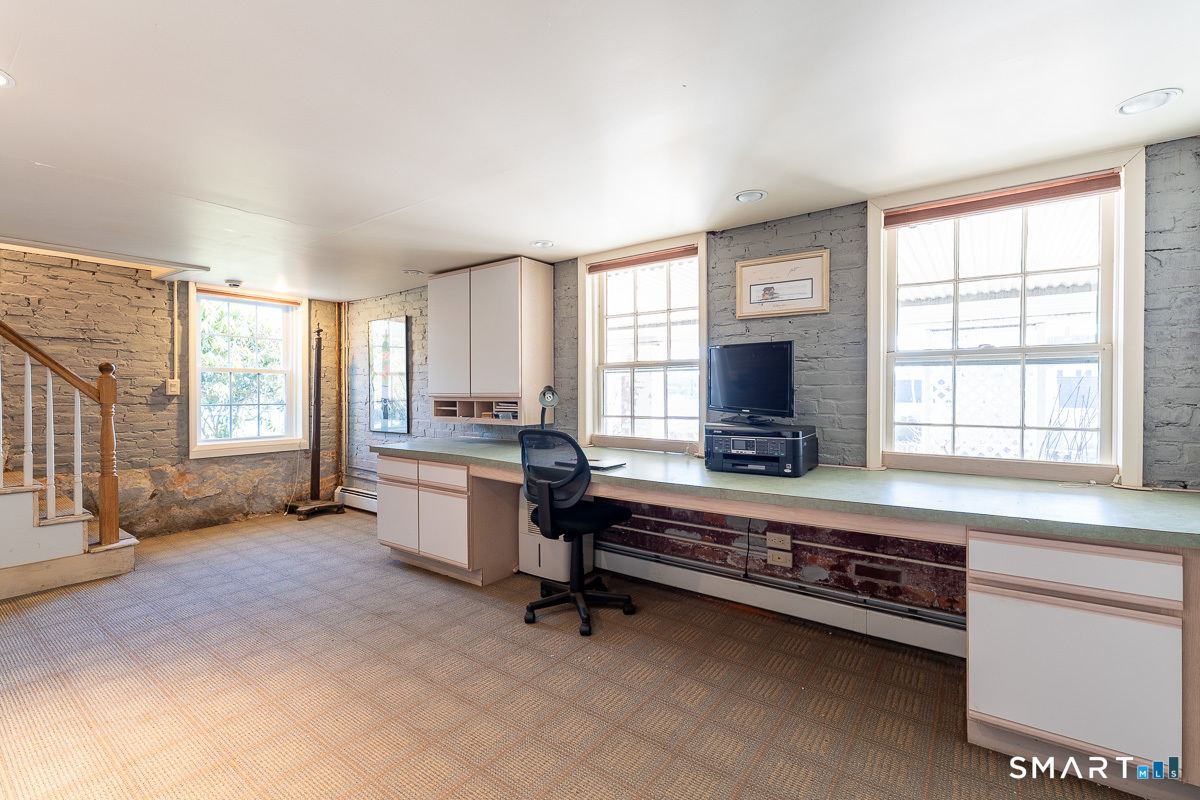 105 River Road Groton, CT 06355 - Photo 38 of 39 a living room with furniture flat screen tv and windows