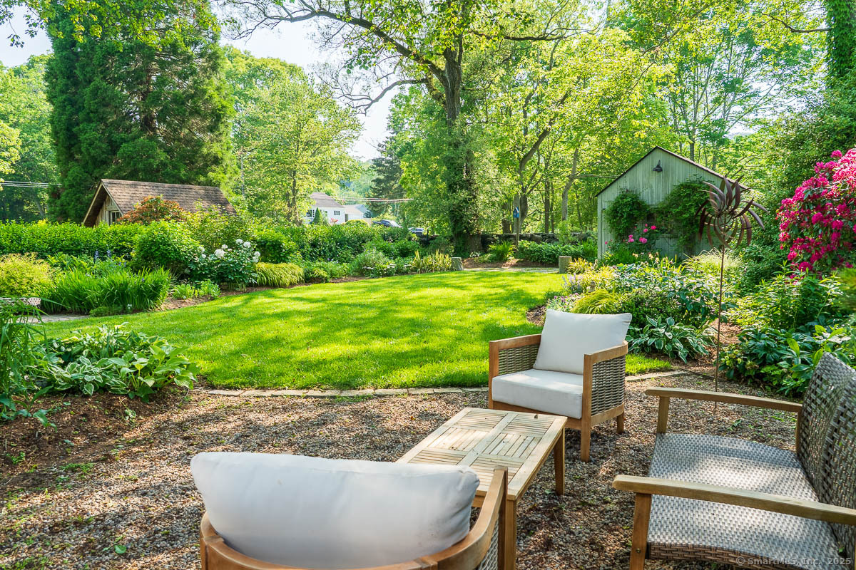 105 River Road Groton, CT 06355 - Photo 5 of 39 a view of a backyard with couches plants and large tree