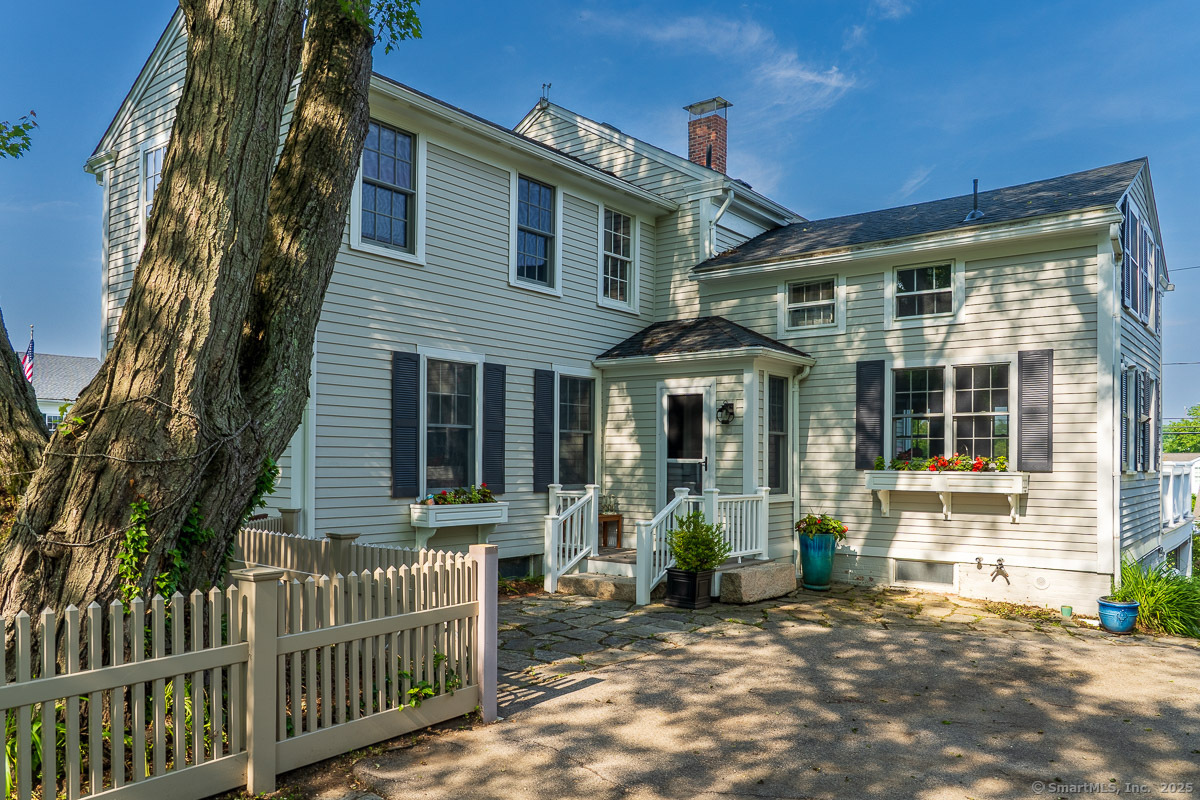 105 River Road Groton, CT 06355 - Photo 6 of 39 a front view of a house with a garden