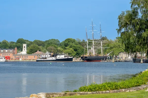 a view of a house with a yard and potted plants