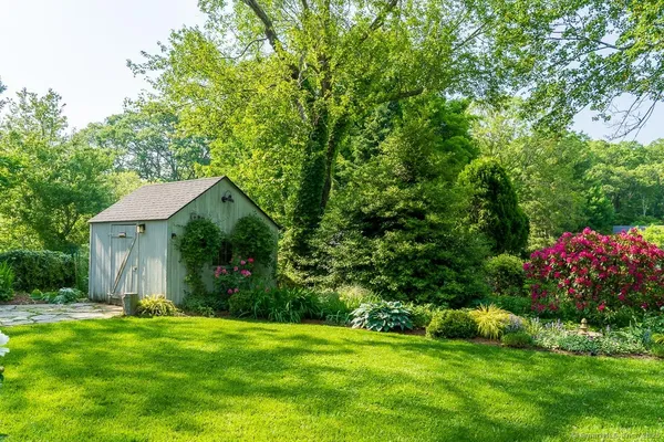 a front view of a house with a yard and fountain