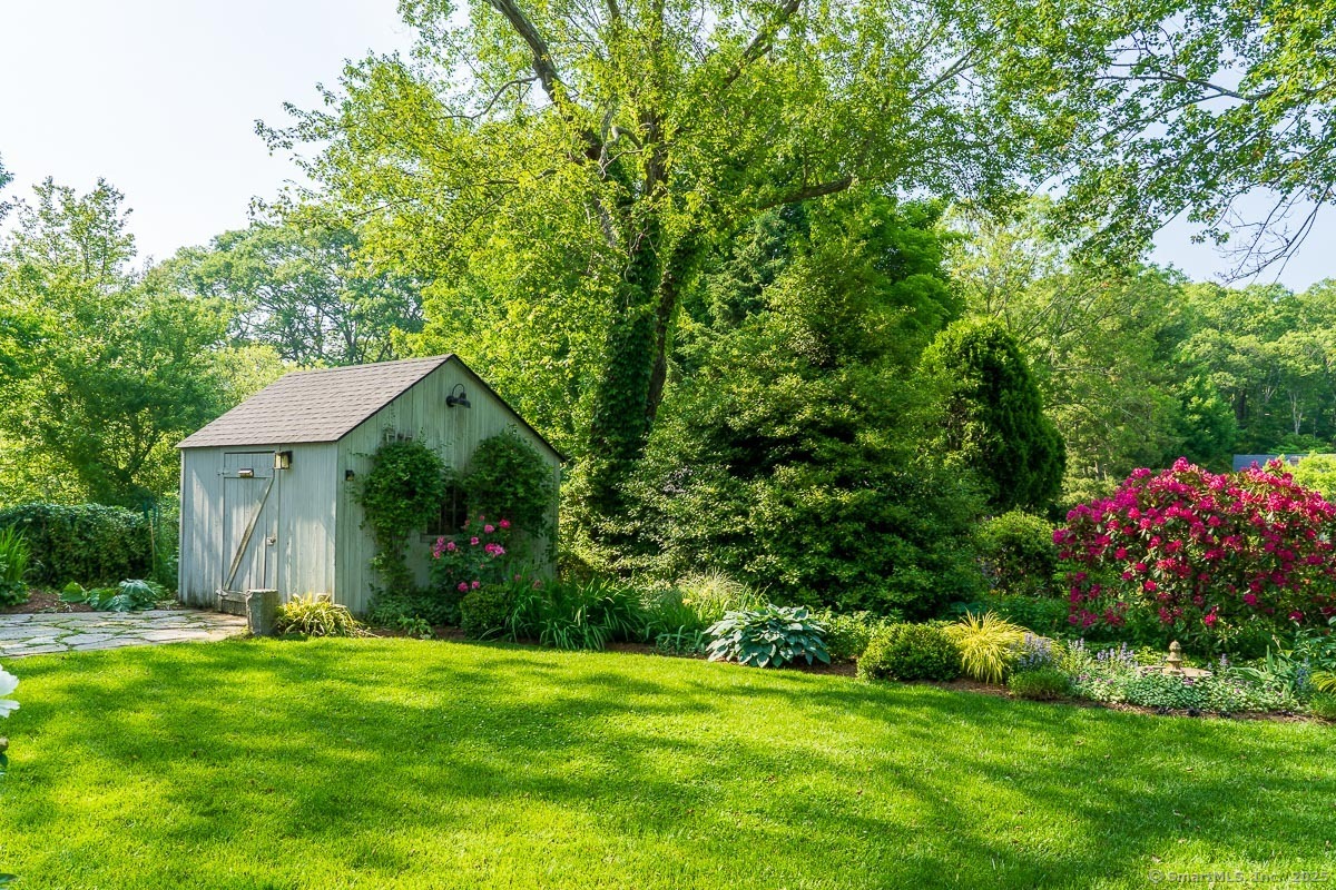105 River Road Groton, CT 06355 - Photo 9 of 39 a front view of a house with a yard and fountain