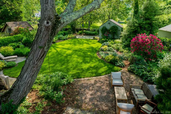 a backyard of a house with lots of green space and plants