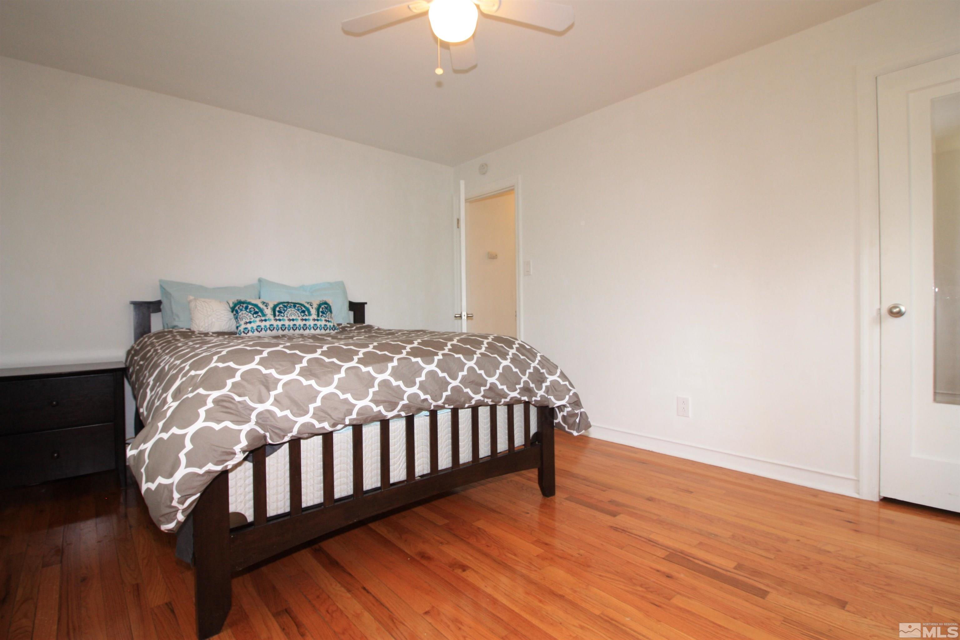 540 Toiyabe Street Reno, NV 89509 - Photo 16 of 29 a bedroom with a bed and wooden floor