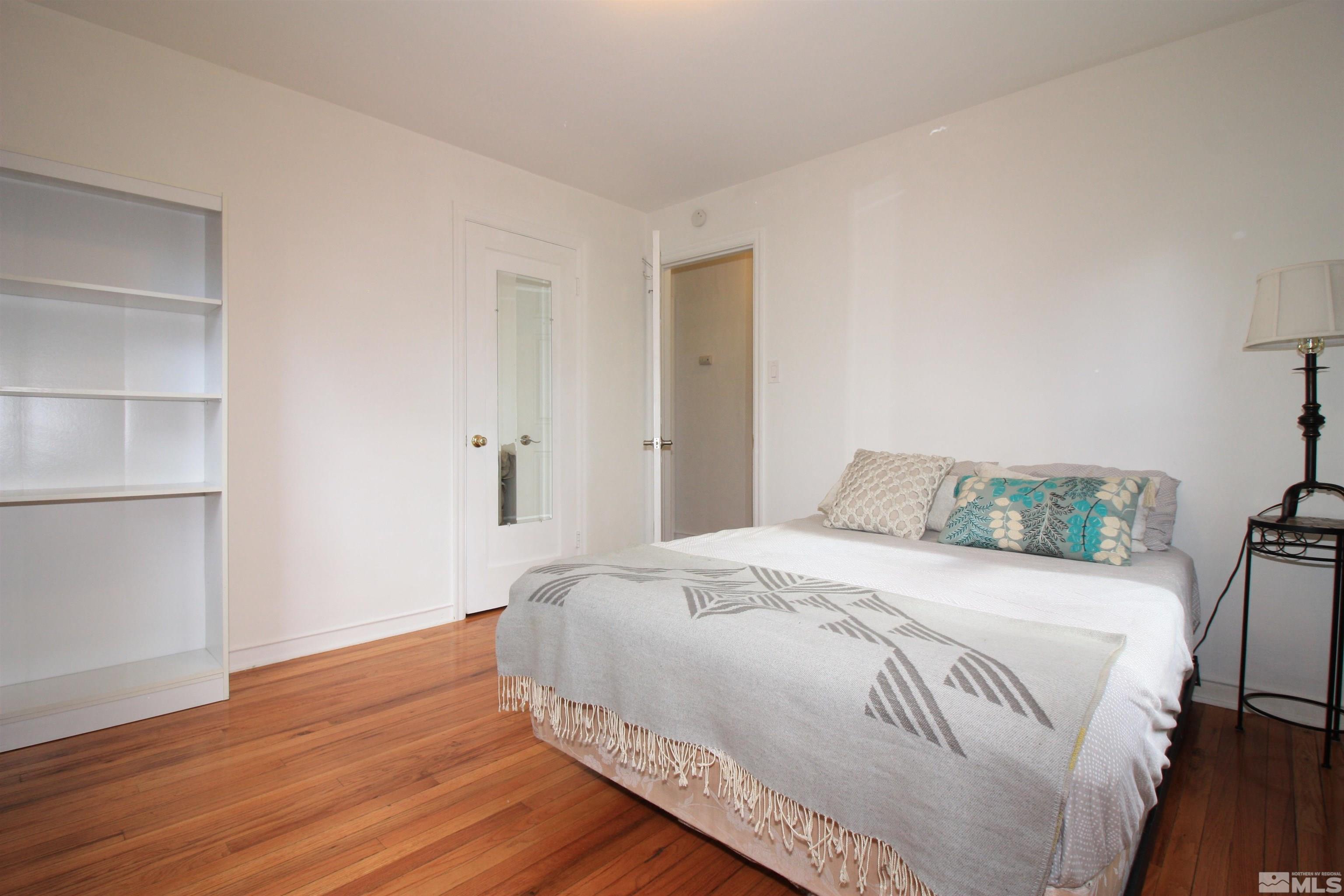 540 Toiyabe Street Reno, NV 89509 - Photo 18 of 29 a bedroom with a bed and wooden floor