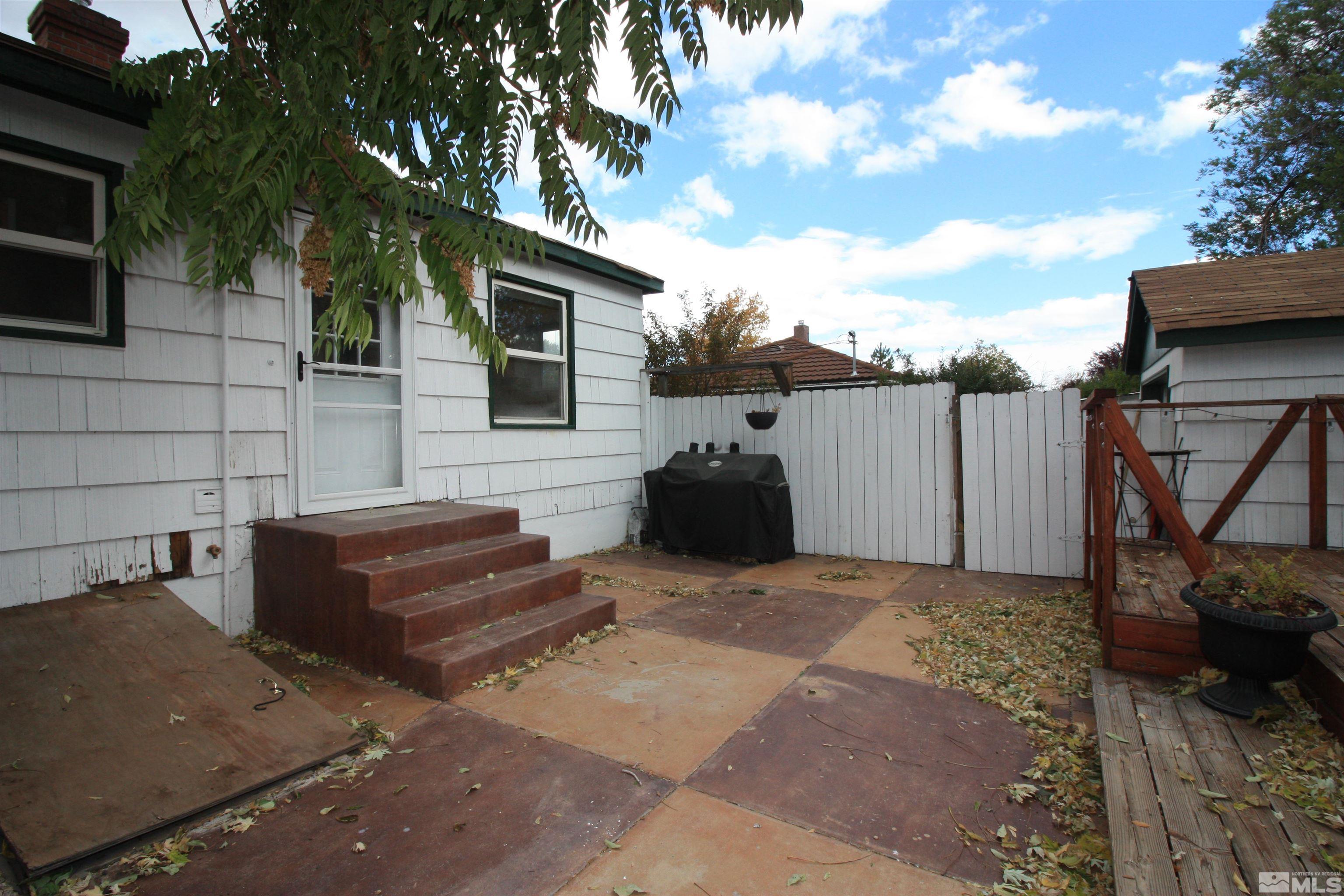 540 Toiyabe Street Reno, NV 89509 - Photo 24 of 29 a backyard of a house with barbeque oven and outdoor seating