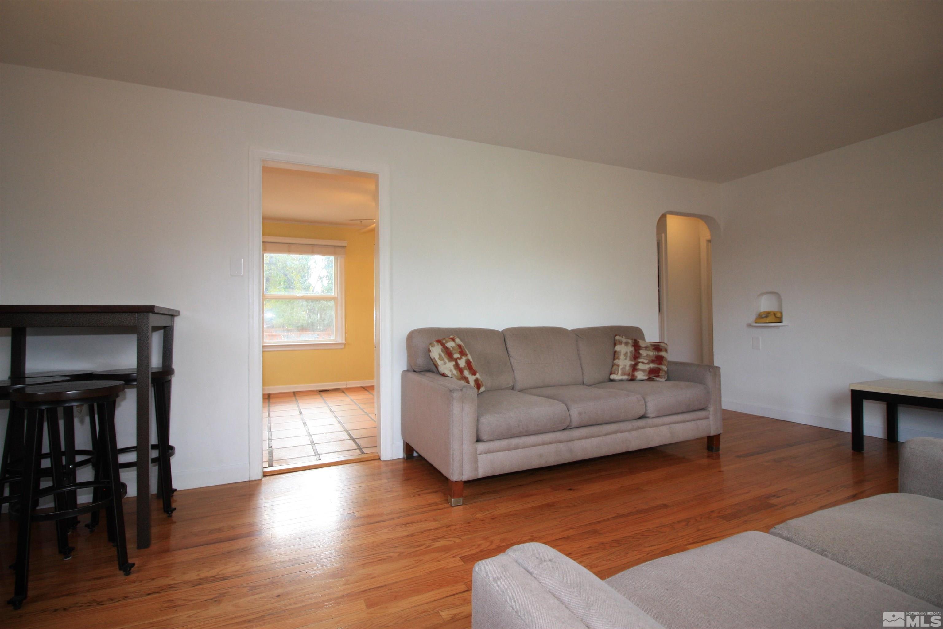 540 Toiyabe Street Reno, NV 89509 - Photo 3 of 29 a living room with furniture and a wooden floor
