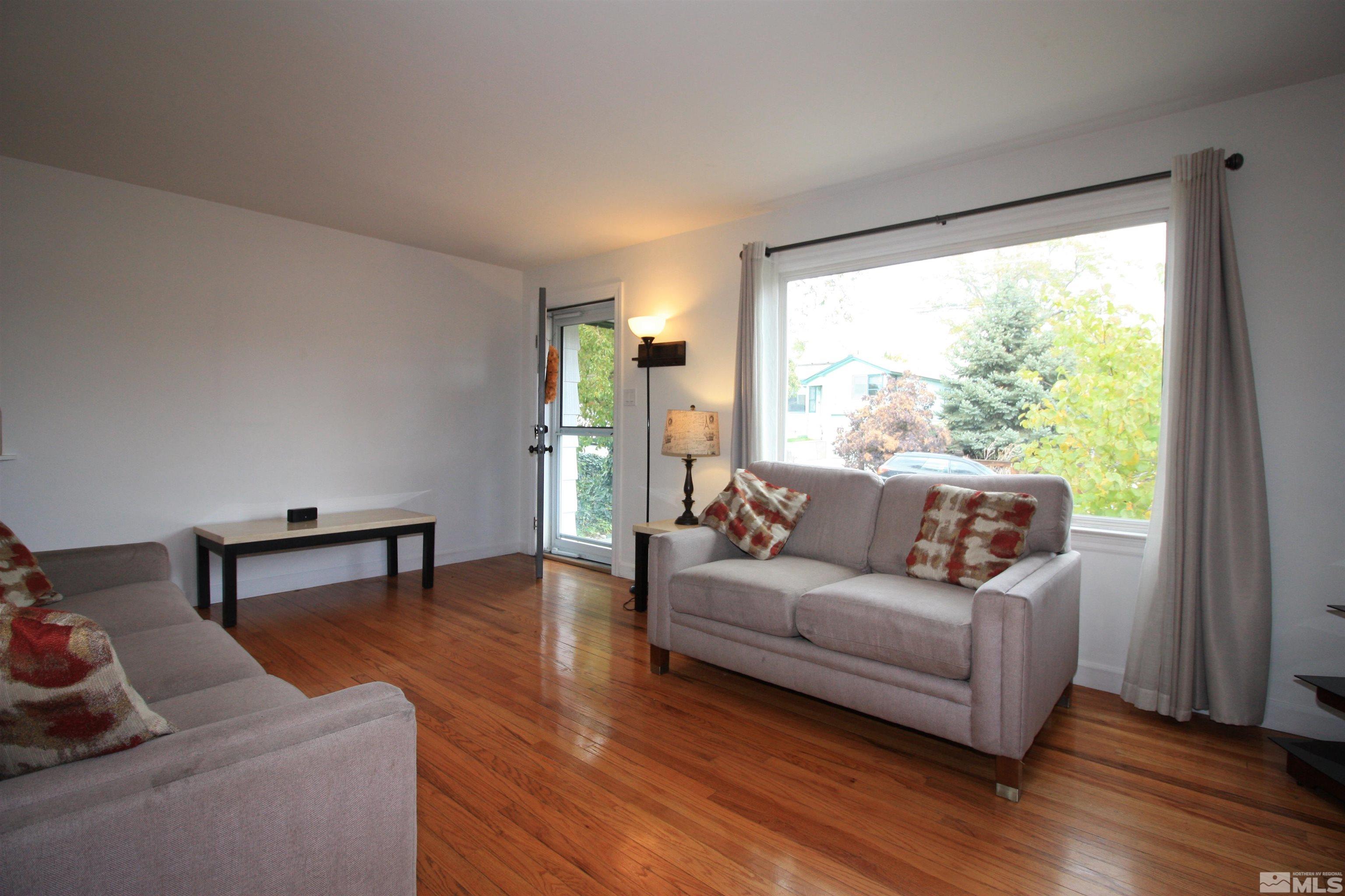 540 Toiyabe Street Reno, NV 89509 - Photo 5 of 29 a living room with furniture and a wooden floor