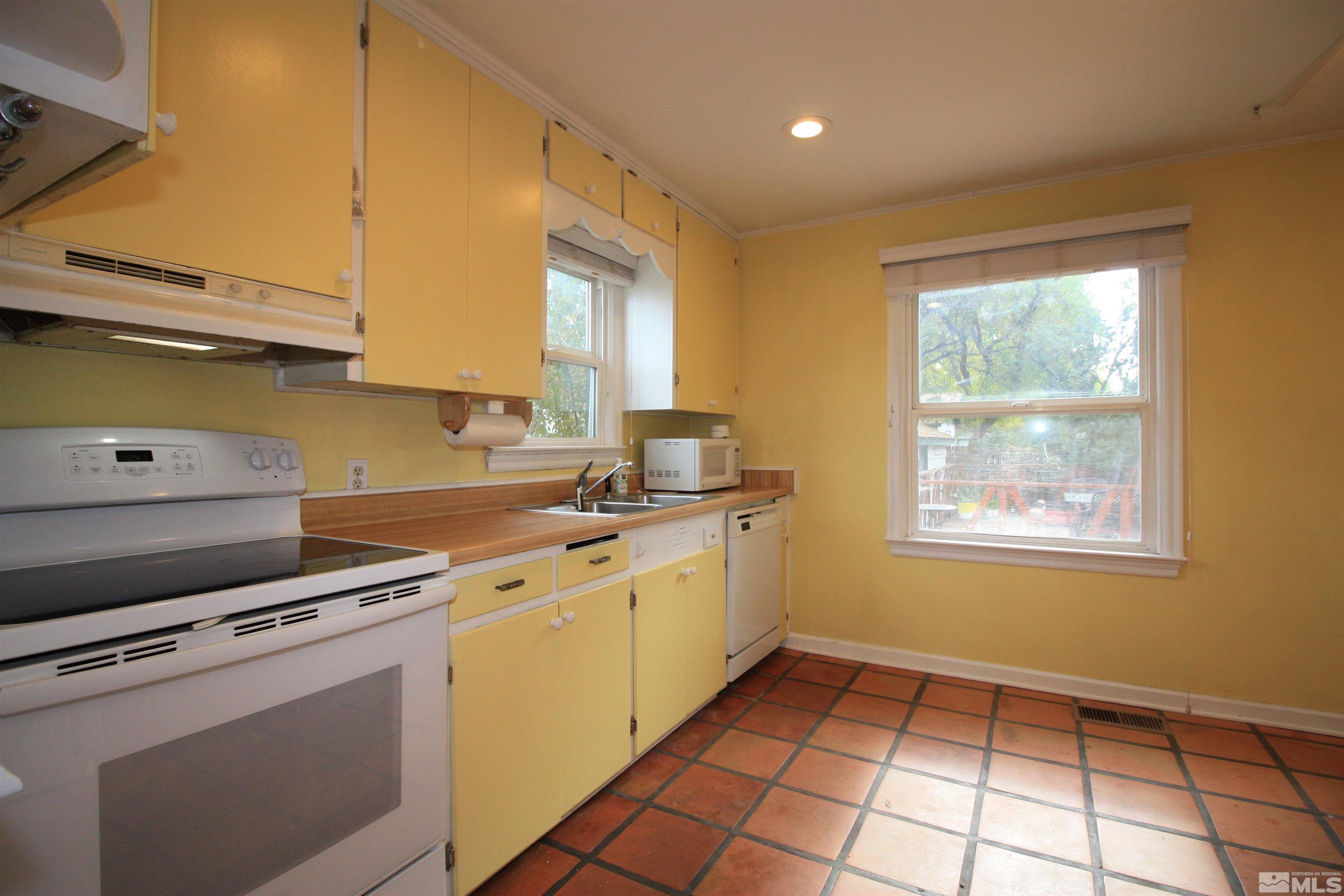 540 Toiyabe Street Reno, NV 89509 - Photo 6 of 29 a kitchen with a stove a sink and a window