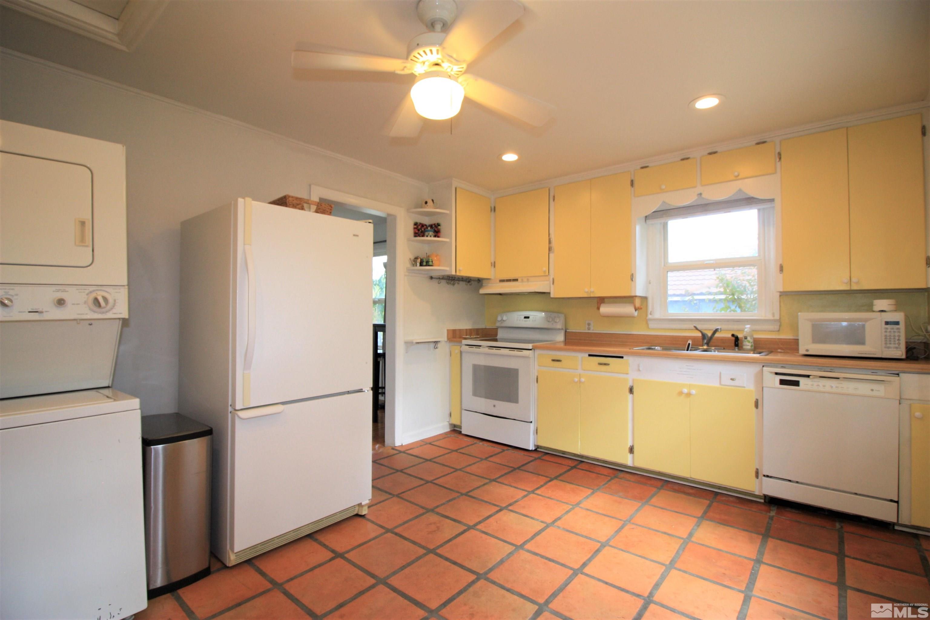 540 Toiyabe Street Reno, NV 89509 - Photo 8 of 29 a kitchen with a refrigerator a sink and dishwasher