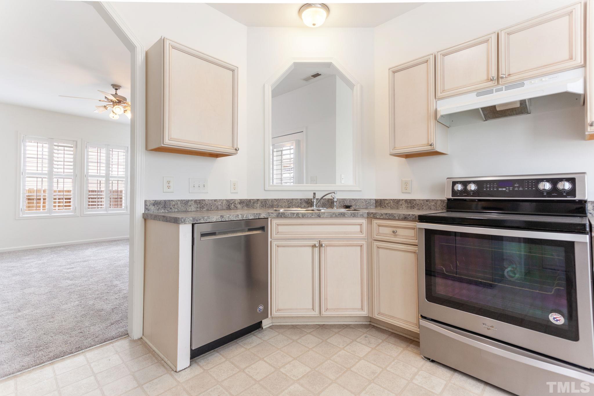 6810 Spanglers Spring Way Raleigh, NC 27610 - Photo 4 of 24 a kitchen with granite countertop white cabinets and appliances