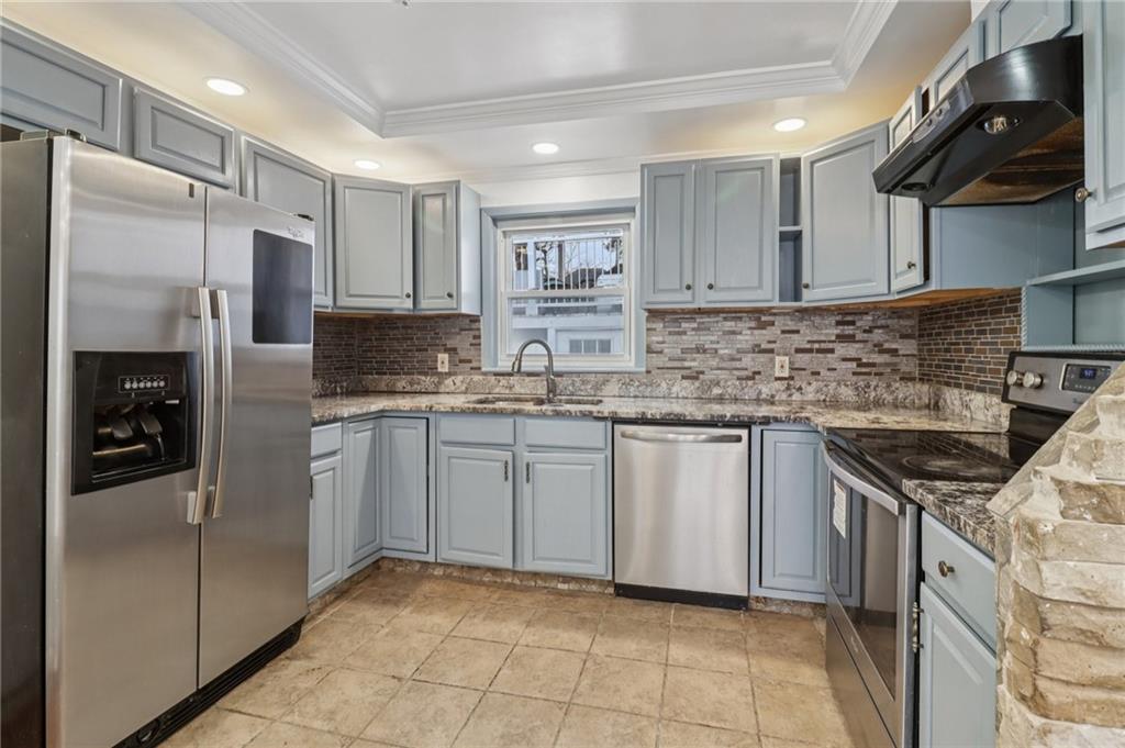 716 Carolina Road Marietta, GA 30008 - Photo 21 of 71 a kitchen with stainless steel appliances granite countertop a refrigerator sink and stove