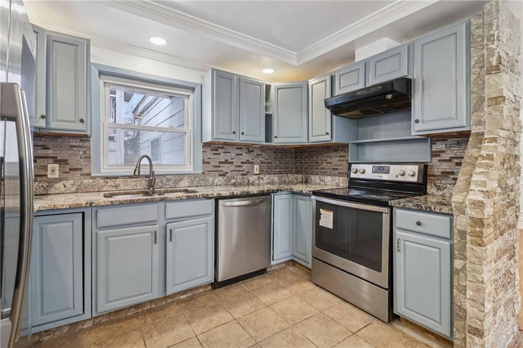 716 Carolina Road Marietta, GA 30008 - Photo 22 of 71 a kitchen with stainless steel appliances granite countertop a sink stove and microwave