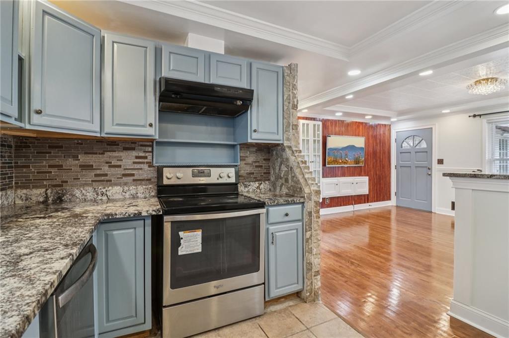716 Carolina Road Marietta, GA 30008 - Photo 24 of 71 a kitchen with stainless steel appliances granite countertop a stove a sink and a microwave